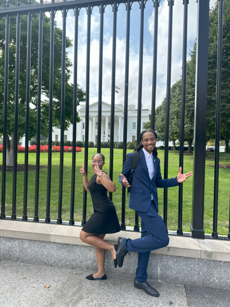 Breon Robinson and Gregory Swafford pose in front of the White House while advocating against the Energy Permitting Reform Act