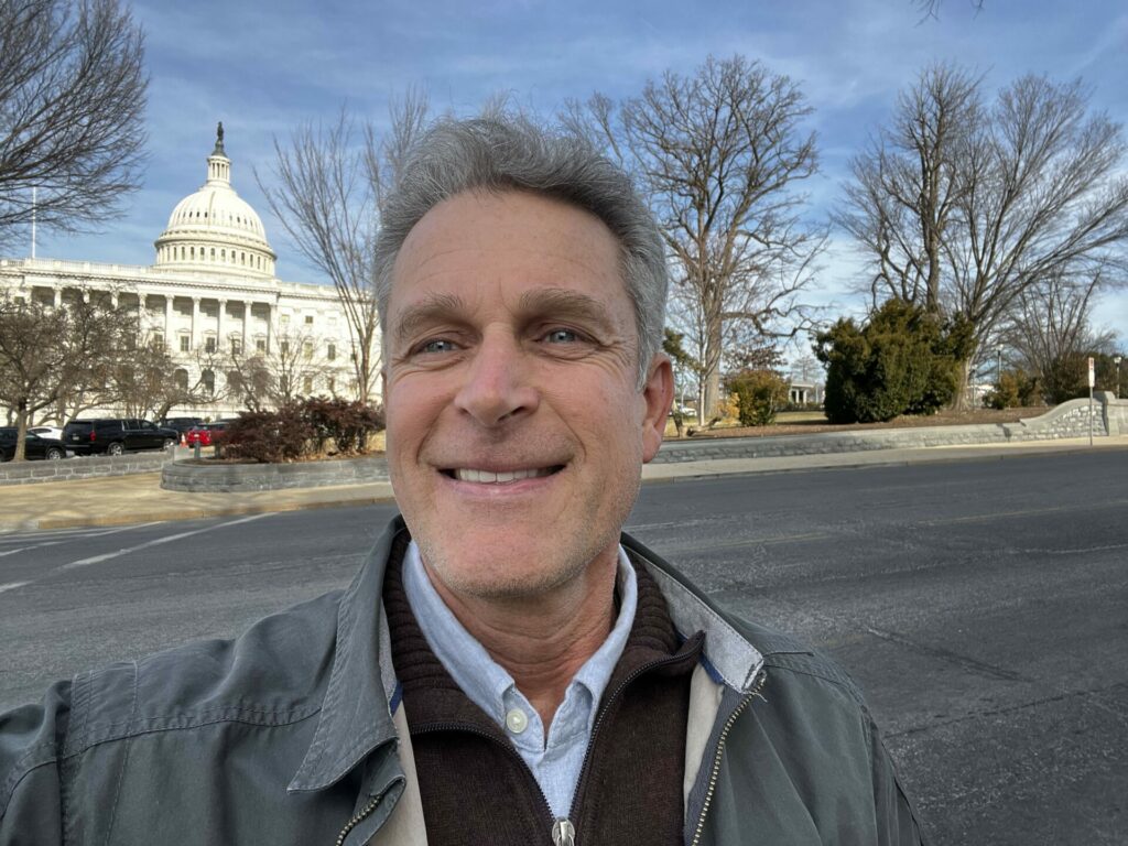 Christian Wagley snaps a photo in front of the U.S. Capitol Building